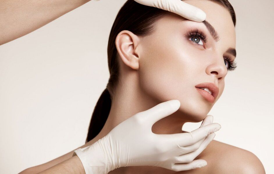 Cosmetologist checks facial skin before rejuvenation
